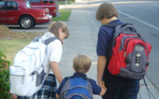 siblings walking to school together