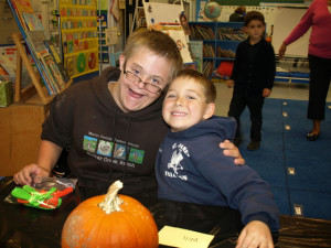 Patrick with his kindergarten Buddy, Will, carving pumpkins.