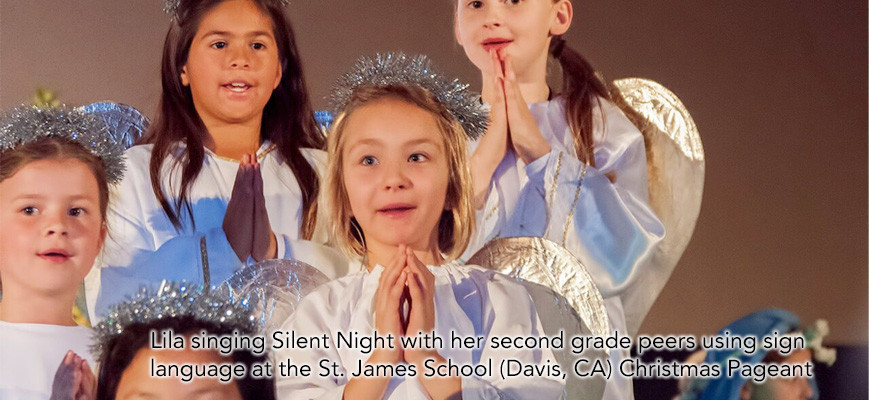Lila singing Silent Night with her second grade peers using sign language at the St. James Christmas Pageant.